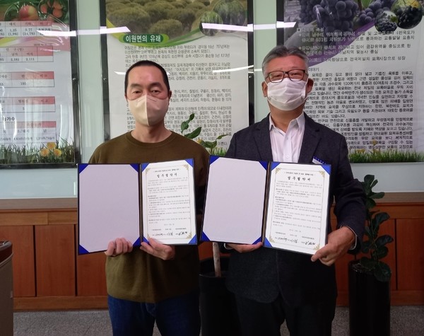 이기범 대표(왼쪽)와 김연철 이원면장이 정기 후원 협약을 맺고 있다.