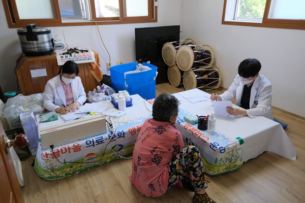 ‘산골마을 행복버스’가 주민들을 상대로 의료서비스를 실시하고 있다.